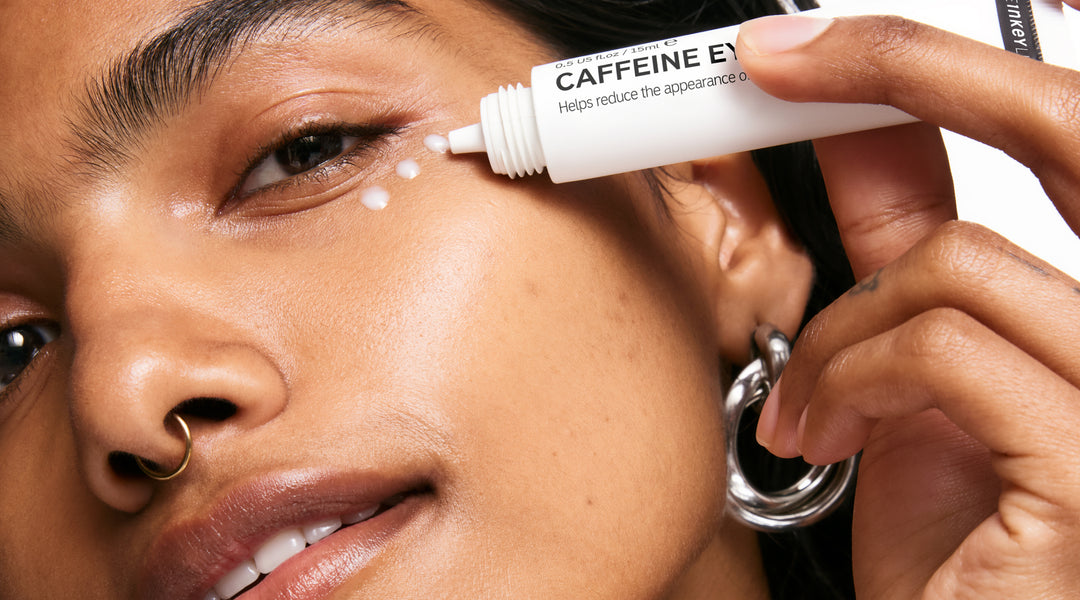 Model applying Caffeine Eye Cream