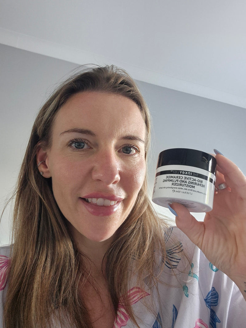 A woman holding a jar of Bio Active Moistuiser to her face
