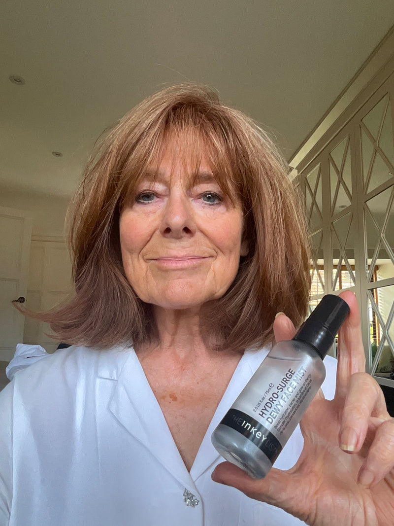 A lady holding a bottle of The Inkey List Mist