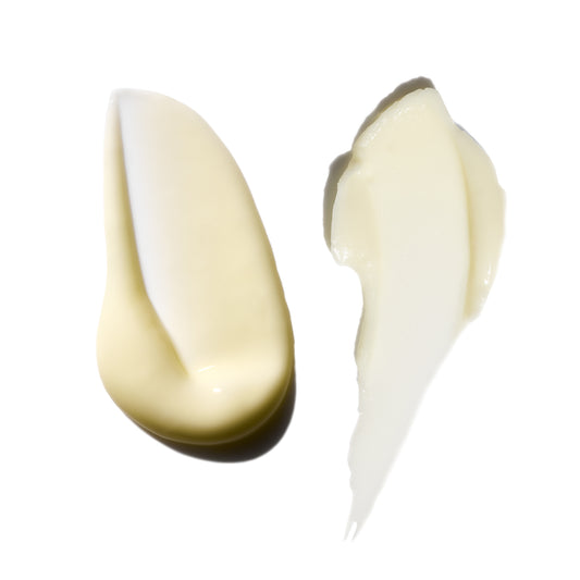 Two swatches of white cream on a white background