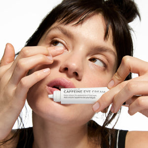 Model applying Caffeine Eye Cream