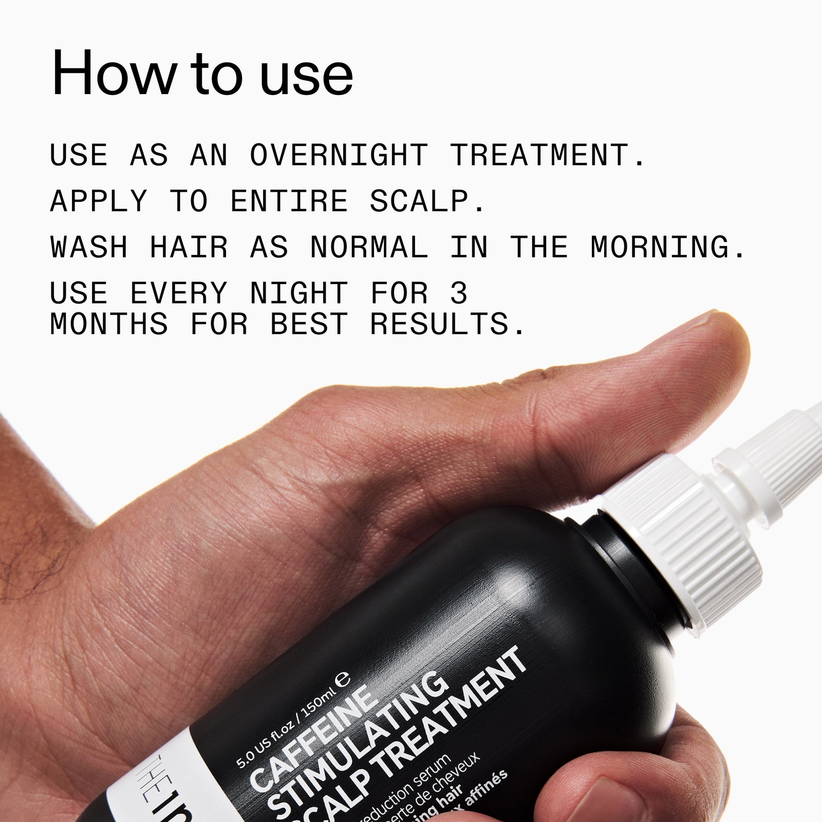 Hand holding a bottle of caffeine stimulating scalp treatment with usage instructions.