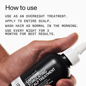 Hand holding a bottle of caffeine stimulating scalp treatment with usage instructions.