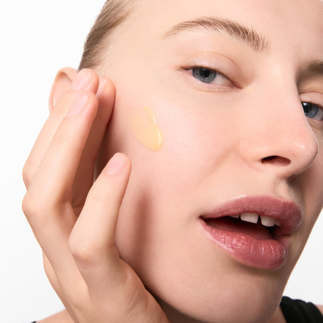 Women with  Retinol Serum on her cheek