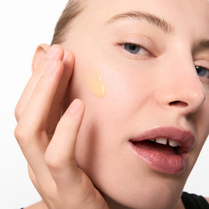 Women with Retinol Serum on her cheek