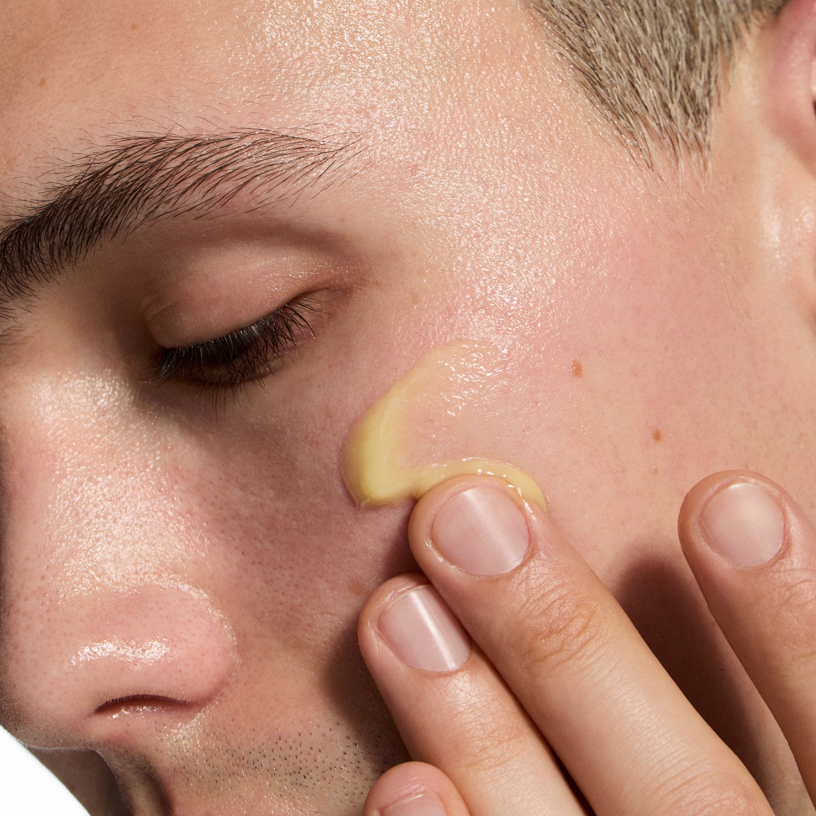 Close-up of a person applying Exosome Hydro-Glow Complex to their face