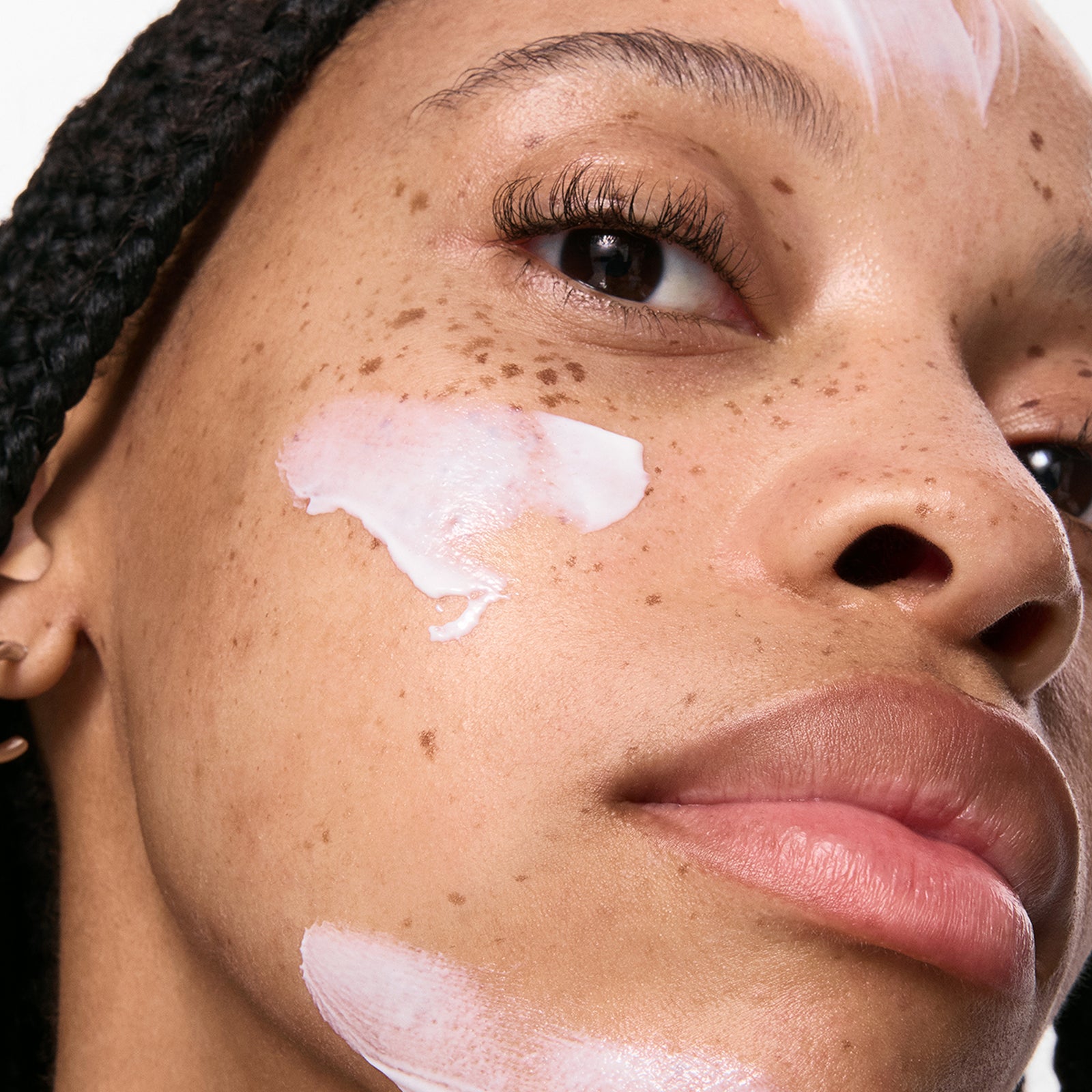 close up of model with SPF on her face