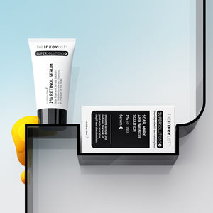 Scar, Mark & Wrinkle Solution bottle and packaging on a shelf against blue background with yellow goop