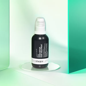 PCA Bond Repair Hair Treatment product against a glossy green background
