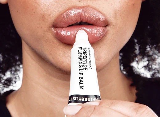  Model applying the Tripeptide Plumping Lip Balm 