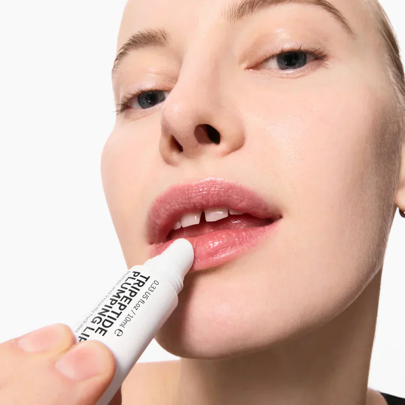model applying lip balm