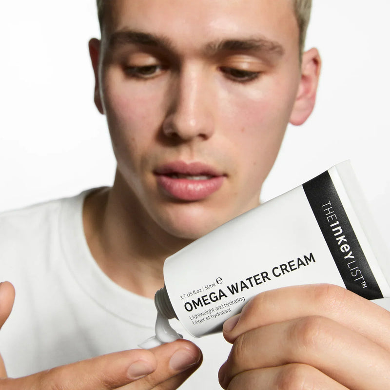 man holding omega water cream