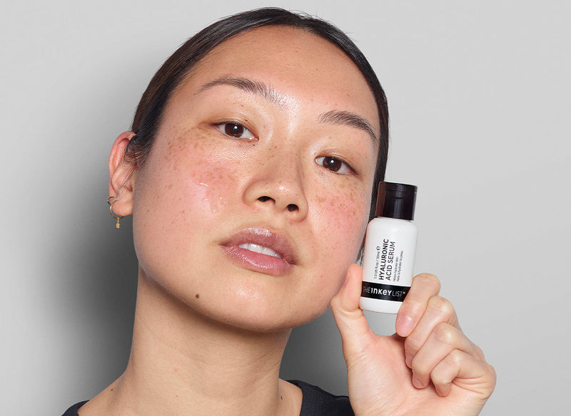 Model holding a serum bottle