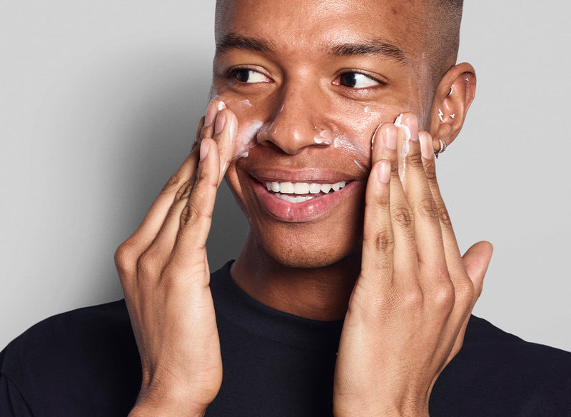 Male model applying product to their face