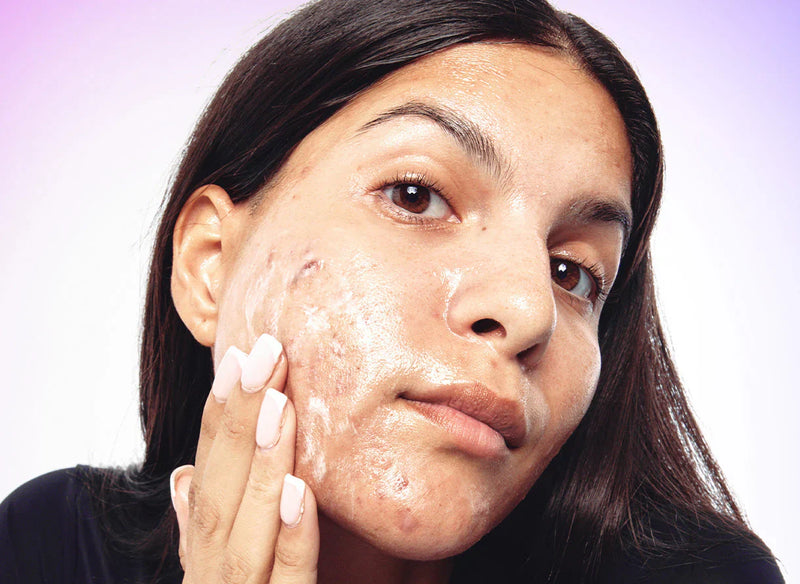 woman washing her face