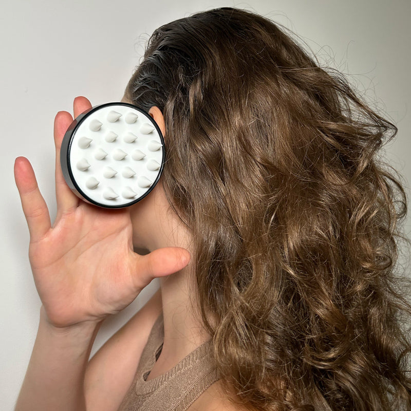 scalp massager and woman in the shower