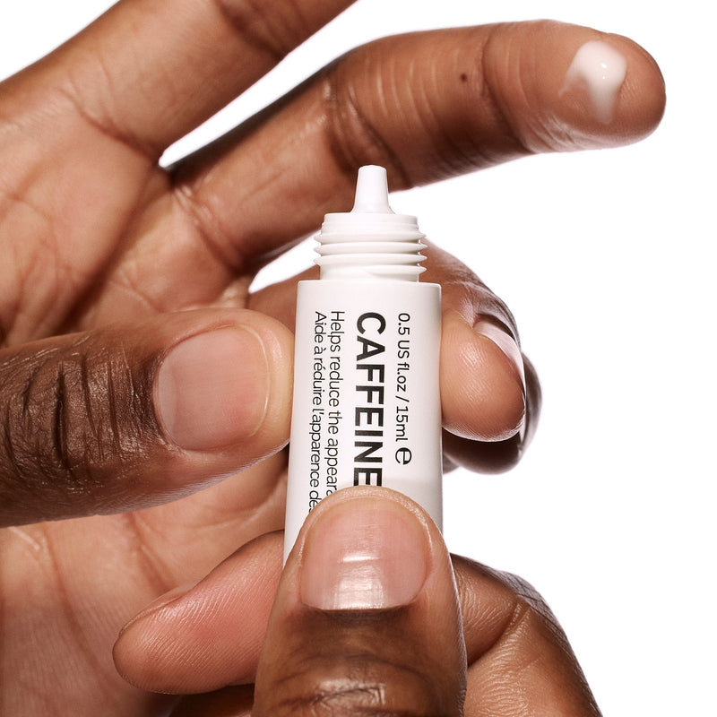 caffeine eye cream on fingertip