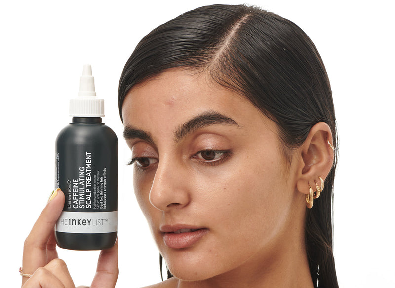 Model holding Caffeine Scalp Treatment