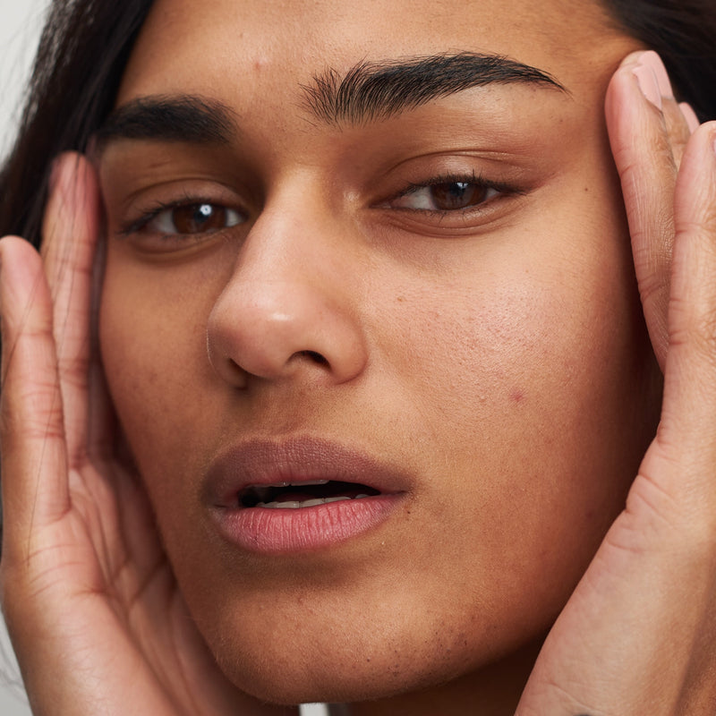 woman holding her face