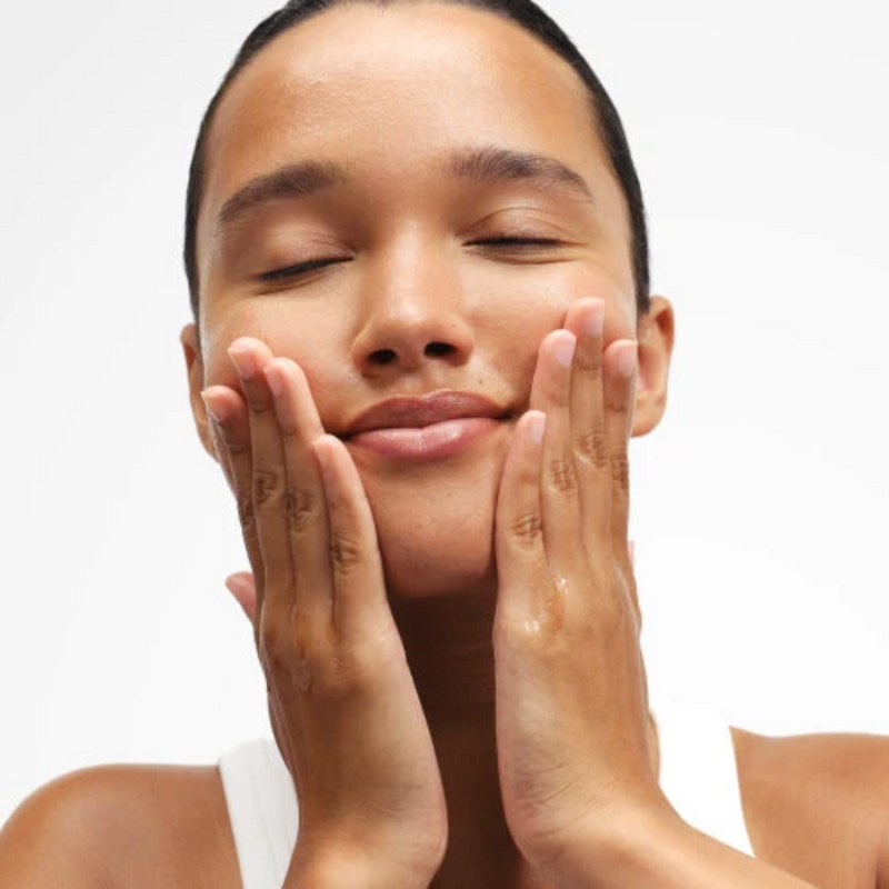 woman touching her face