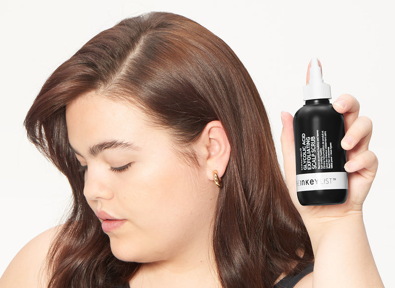 Model holding The INKEY List hair product