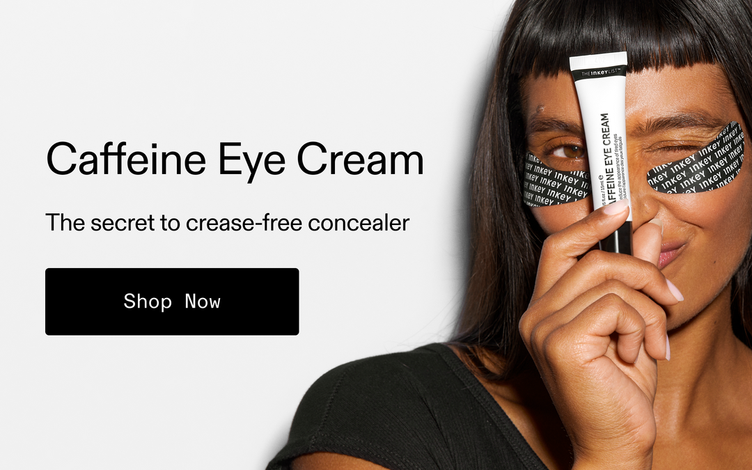 A promotional banner for Caffeine Eye Cream featuring a woman holding a white tube of concealer with black text, with black eye patches on her cheeks. The left side has text reading 'Caffeine Eye Cream', 'The secret to crease-free concealer', and a black 'Shop Now' button on a light gray background.