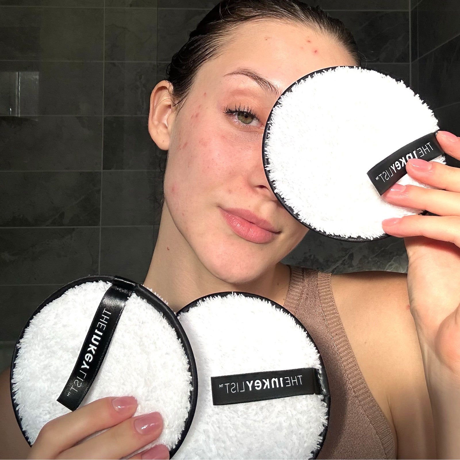 Woman holding 3 Resuable Cotton Pads