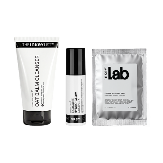 Three skincare products from Inkey Labs arranged side by side on a white background: a white tube labeled Oat Balm Cleanser, a white bottle labeled Exosome Glow, and a silver foil packet labeled Exosome Moisture Mask.