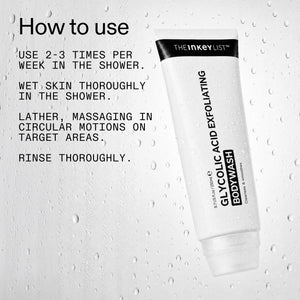 A white tube of The Inkey List Glycolic Acid Exfoliating Body Wash shown on a water-droplet-textured light background with black 'How to use' instructions on the left.
