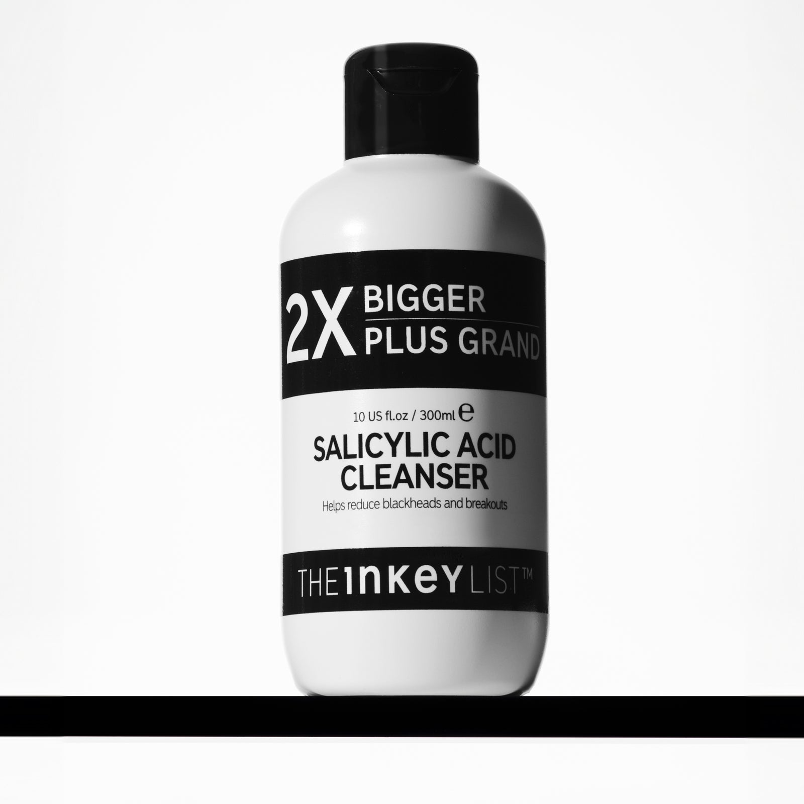 Supersize Salicylic Acid Cleanser bottle with cleanser around it