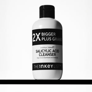 Supersize Salicylic Acid Cleanser bottle with cleanser around it