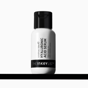 A white bottle of The Inkey List Hyaluronic Acid Serum with a black cap, centered on a white background with a black horizontal bar at the bottom.