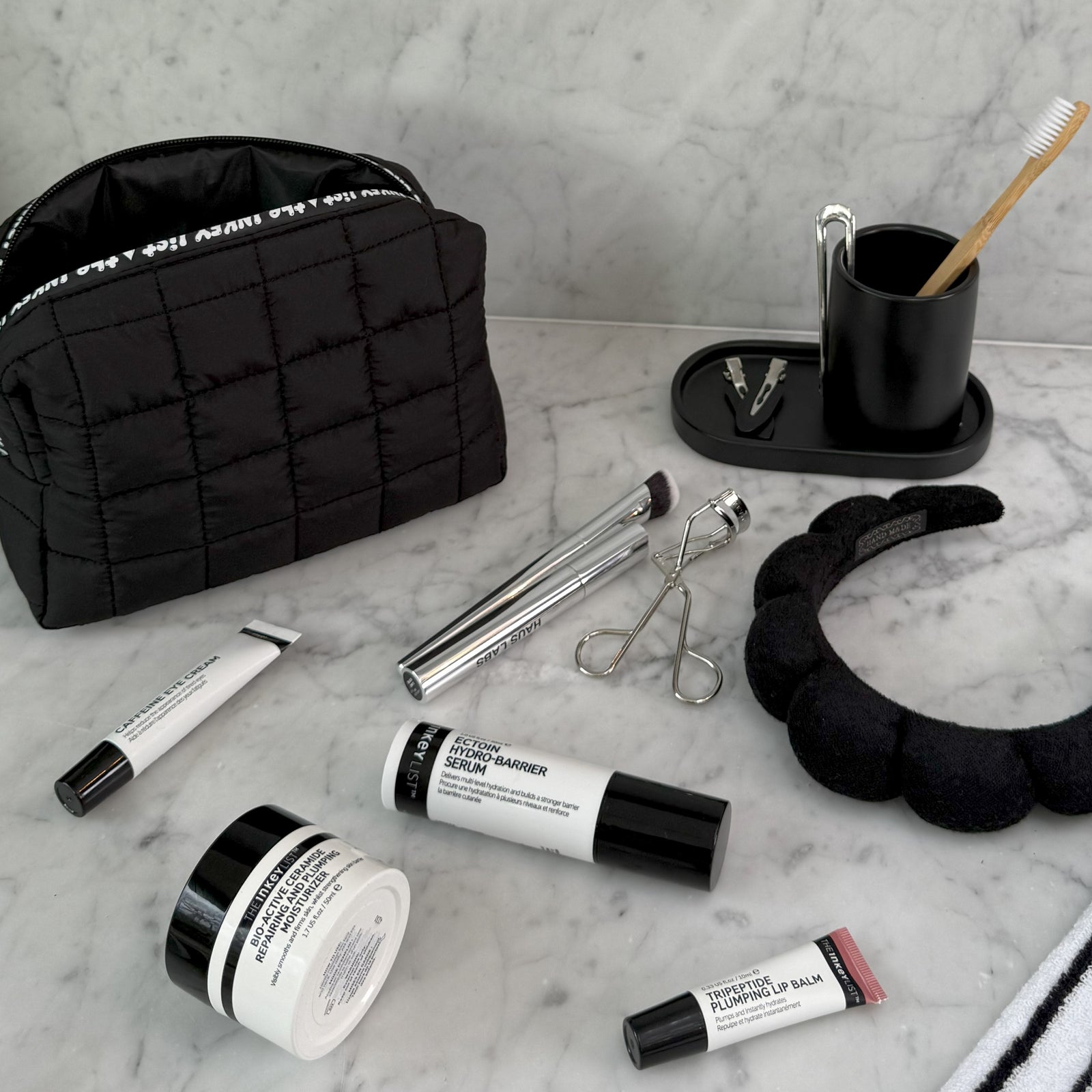 INKEY Wash Bag on marble counter with beauty products