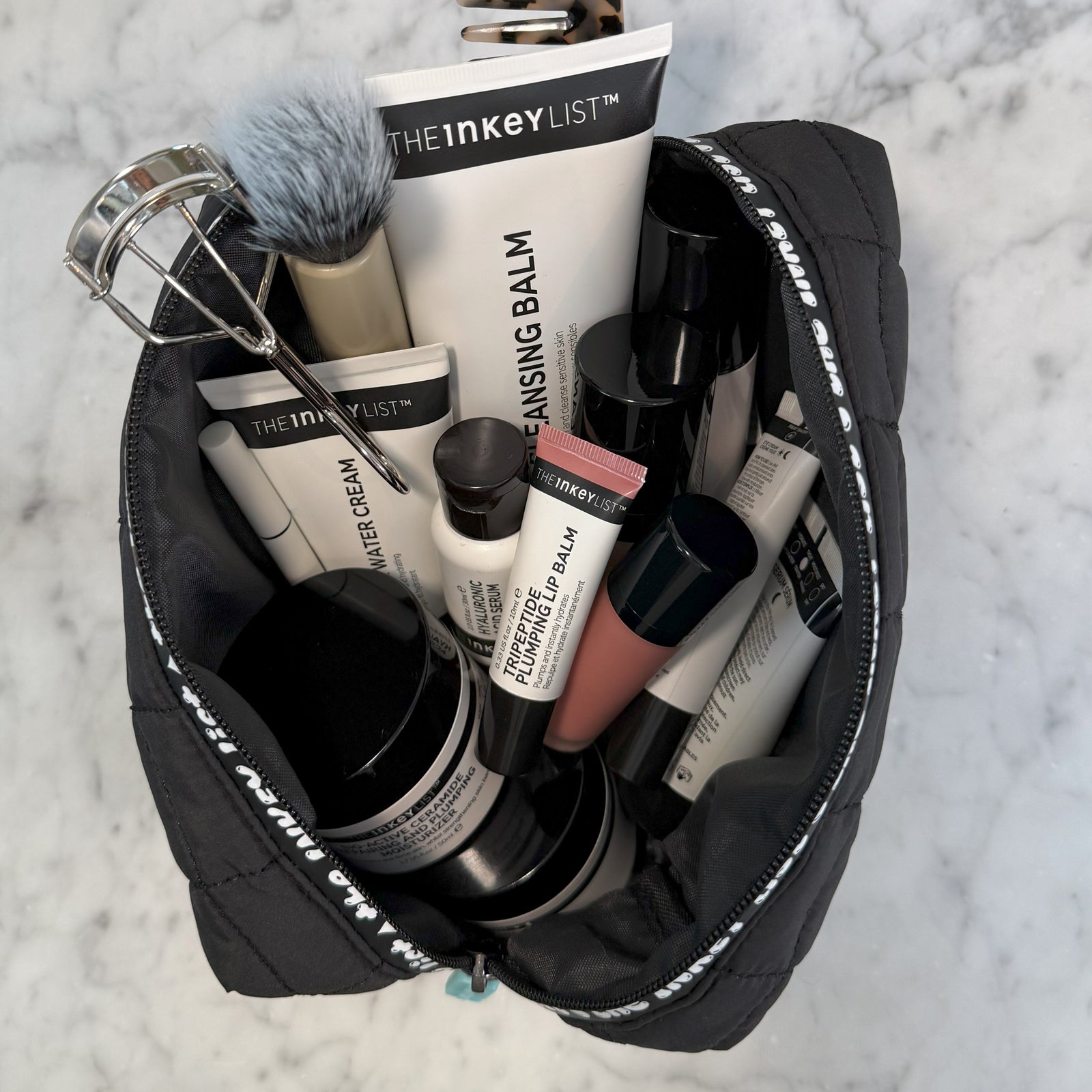 INKEY Wash Bag on marble counter with beauty products