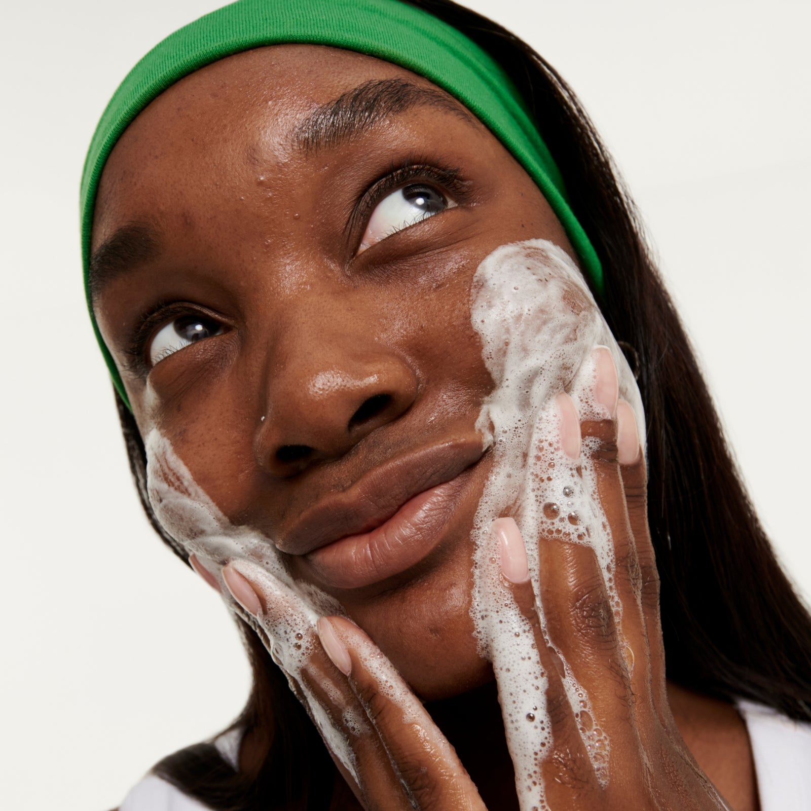 Model washing her face with Salicylic Acid Cleanser