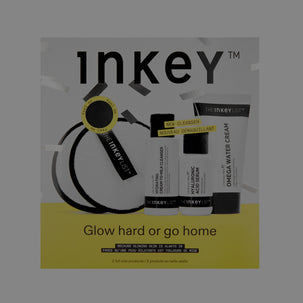 Inkey skincare set packaging featuring a black and white round cleansing pad, a black and white cleanser bottle, a black and white hydrating cream bottle, and a black and white omega water cream tube, with a yellow accent band and the brand name 'inkey' on a dark gray background.