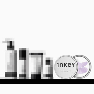 A cosmetic product set featuring a round silver tin labeled 'inkey' and a matching circular lid or second container with a lavender-purple patterned insert, shown alongside several pixelated black-and-white bottle silhouettes on a white background with a black horizontal bar at the bottom.