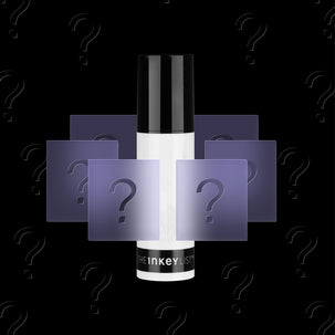 A single cosmetic bottle centered on a black background, with translucent purple squares and question marks layered around it. The bottle appears white and black, and the visible text near the base reads 'theinkeylist'.