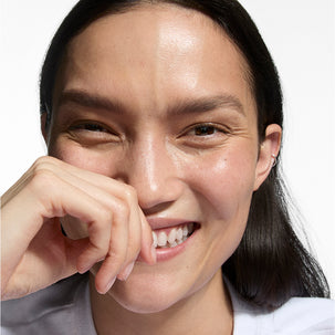 Close-up of a person with a neutral expression on a plain background