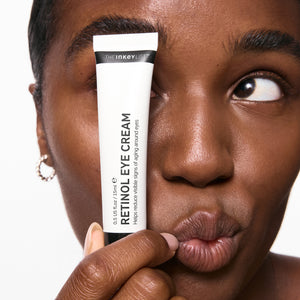 Model holding retinol eye cream