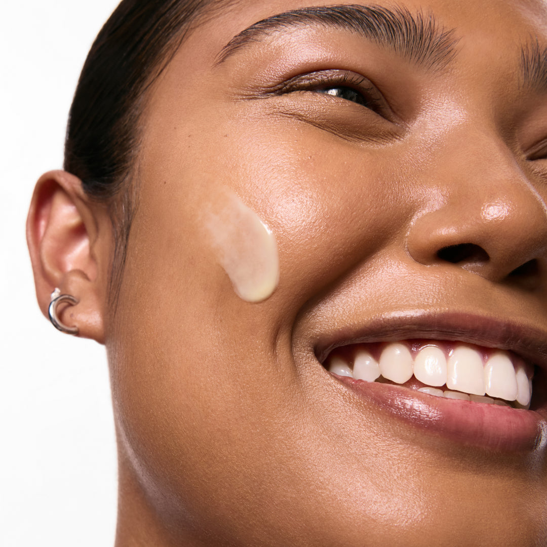 Model with swatch of retinol serum on skin