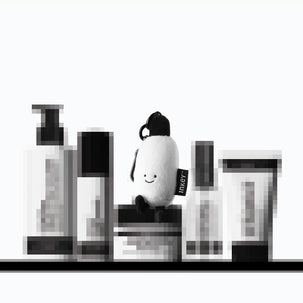 Secret products on a shelf with the free plushie sat on top
