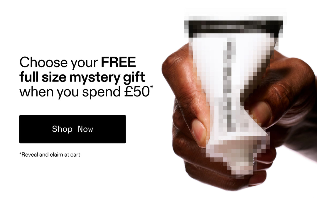 Hand holding a small container with text offering a free full-size mystery gift with a spend of £50.