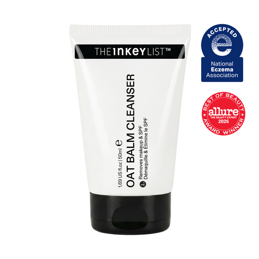 A white and black squeeze tube of THE INKEY LIST Oat Balm Cleanser, shown against a plain white background with two award badges on the right: a blue National Eczema Association Acceptance badge and an Allure Best of Beauty 2026 award badge.