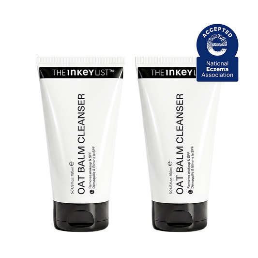 Two white squeeze tubes of THE Inkey List Oat Balm Cleanser with black caps, shown side by side on a white background with a blue National Eczema Association seal in the top right corner.