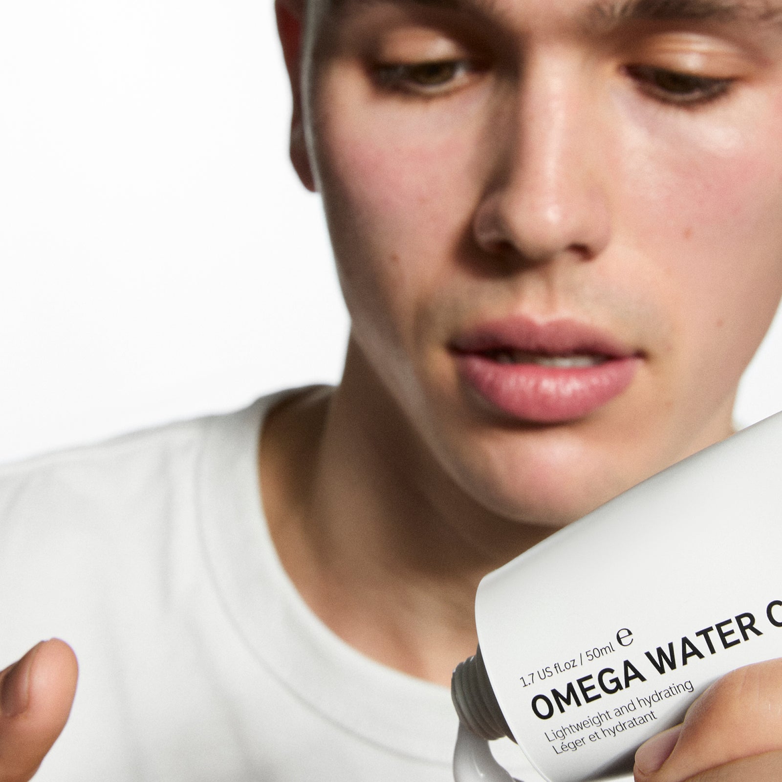 Model with Omega Water Cream on his finger