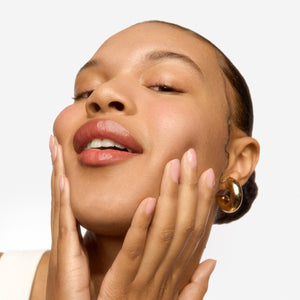 woman touching her face