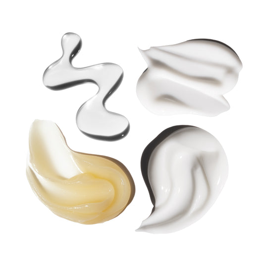 Four swirls of different colored cream on a white background