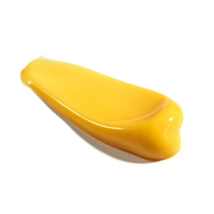 Yellow retinol serum droplet on white background