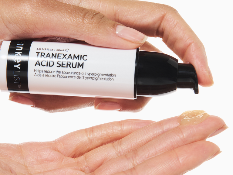 Inky List Tranexamic Acid Serum being applied to a hand with a white background